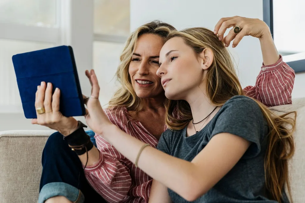 Mum and daughter checking health insurance costs on ipad