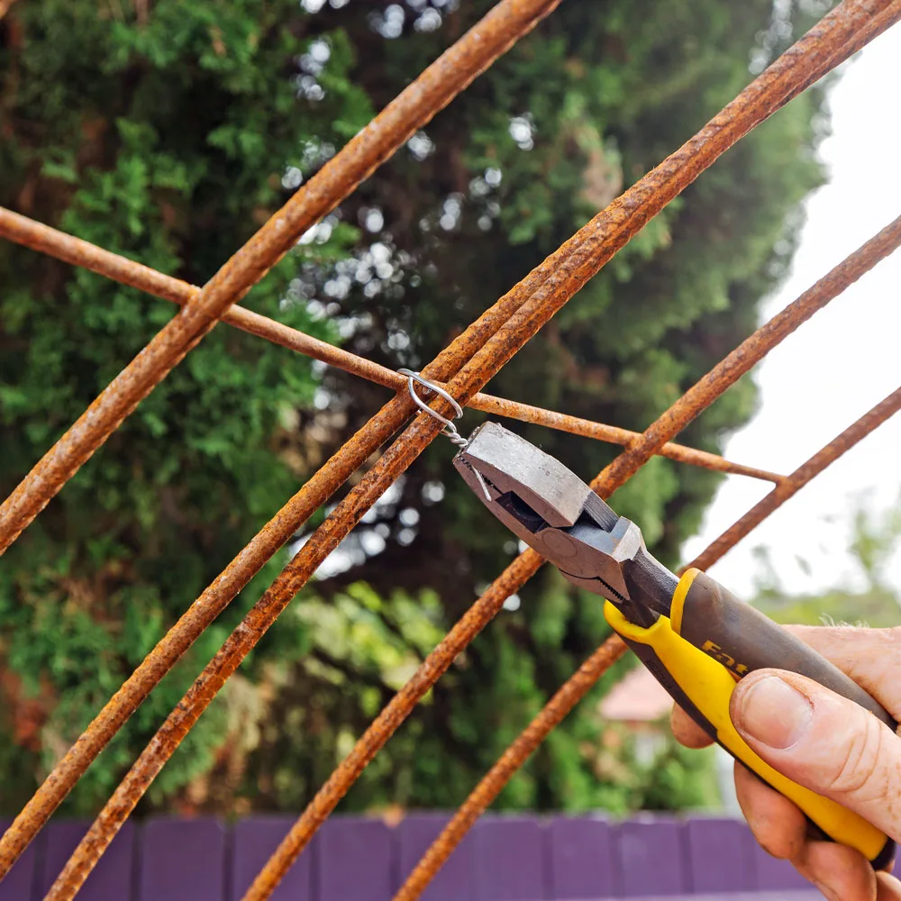Secure the mesh for this metal arch using pliers and tie-wire.