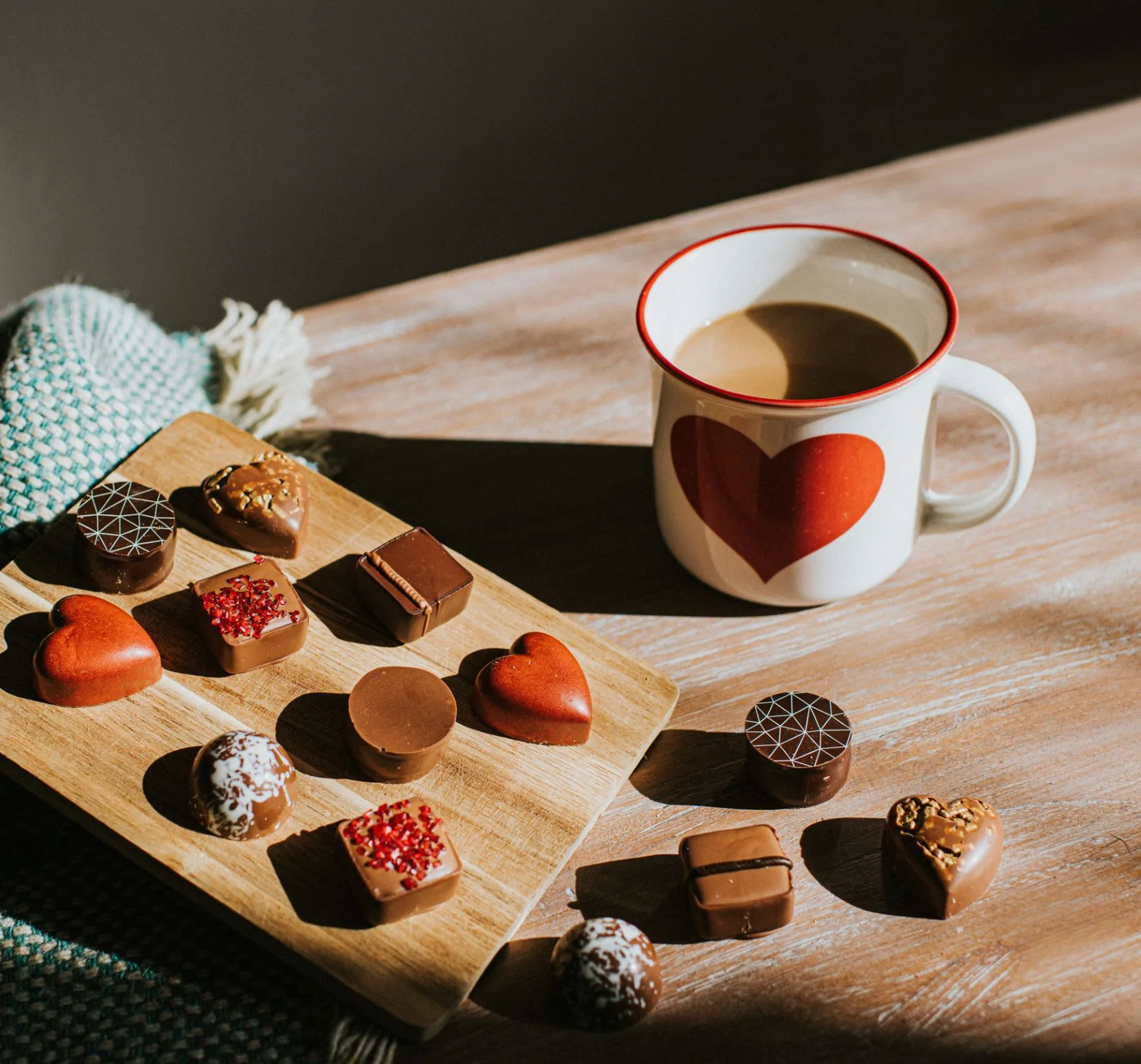 Fancy chocolates and a mug of coffee.