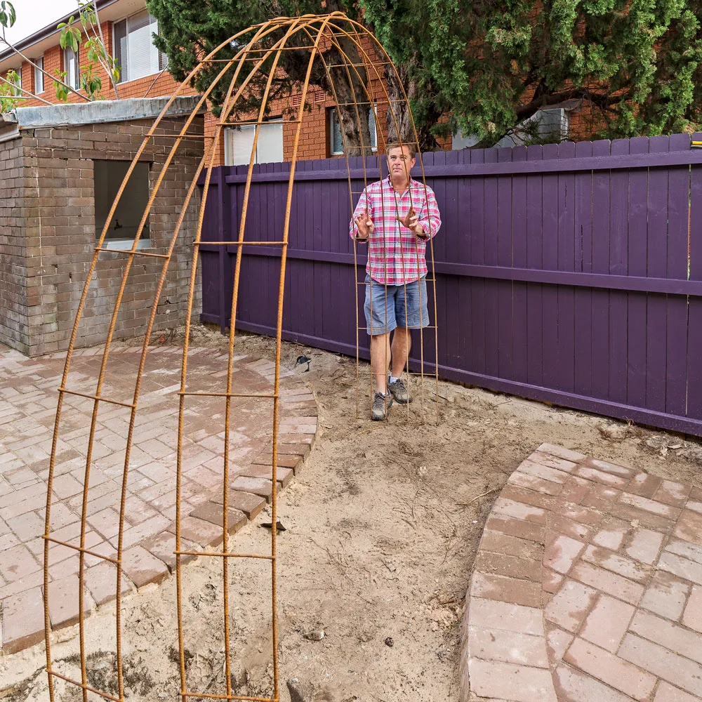 Building a simple metal arbour can add interest to your garden.