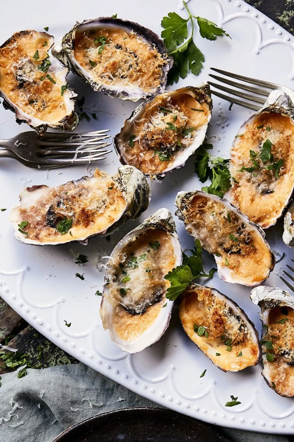 oysters au gratin christmas entree on white plate with forks