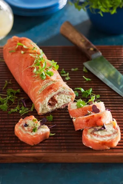 salmon roulade cut into several slices and knife in the background
