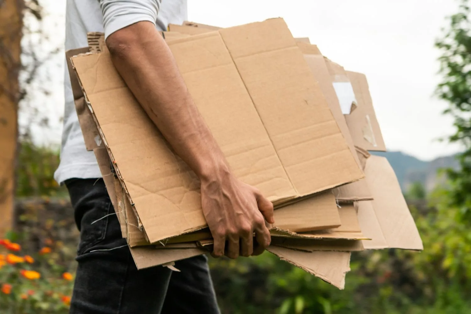 A cardboard weed barrier is affordable and a way to re-use old cardboard you have at home.