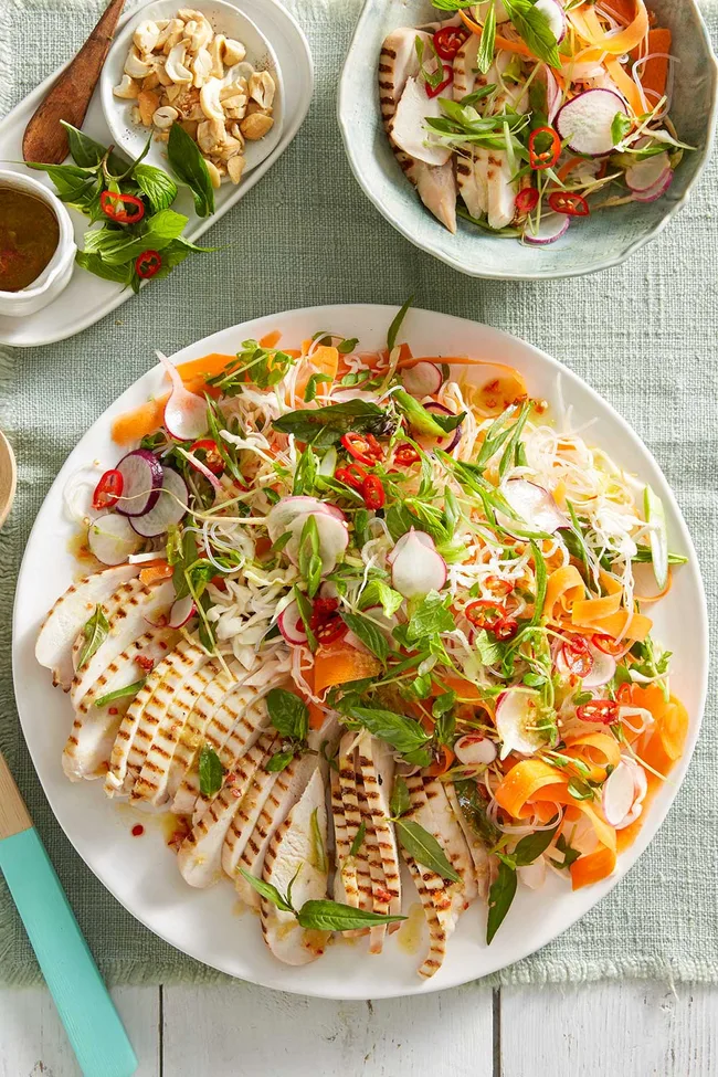 Thai chicken salad with chicken splayed on the side