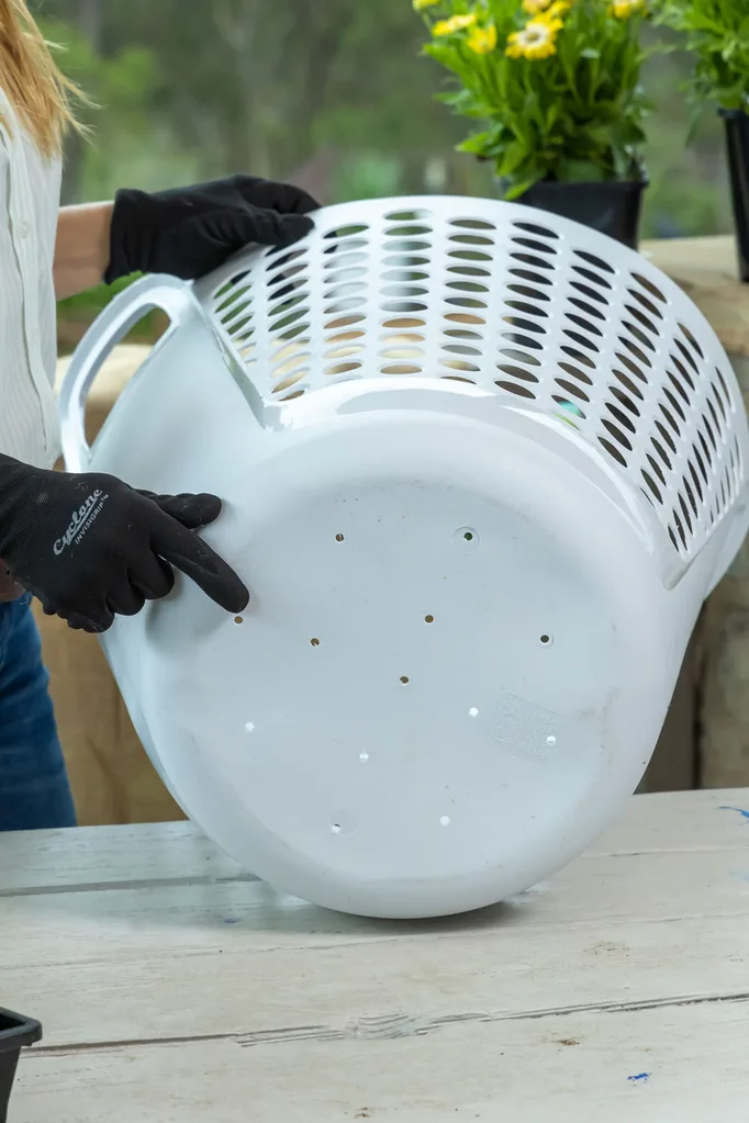 diy strawberry planter step one melissa king is holding a white washing basket