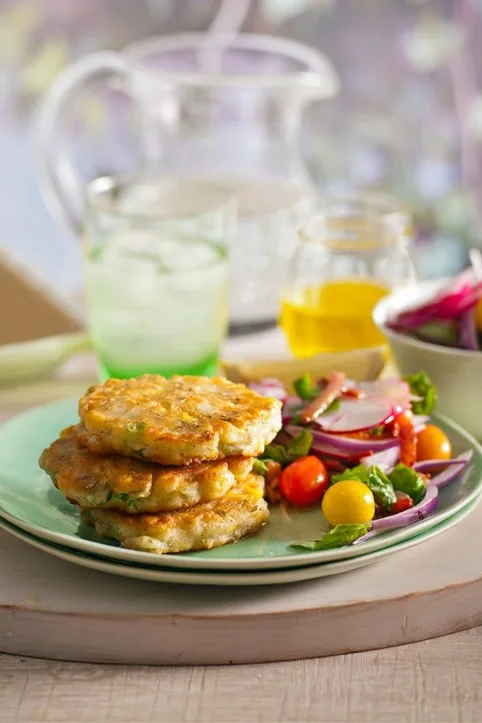 corn best fritter recipes with radish tomato salad on the side of blue bowl