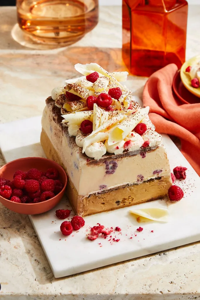 Tiramisu flavoured ice cream cake topped with shaved white chocolate and raspberries