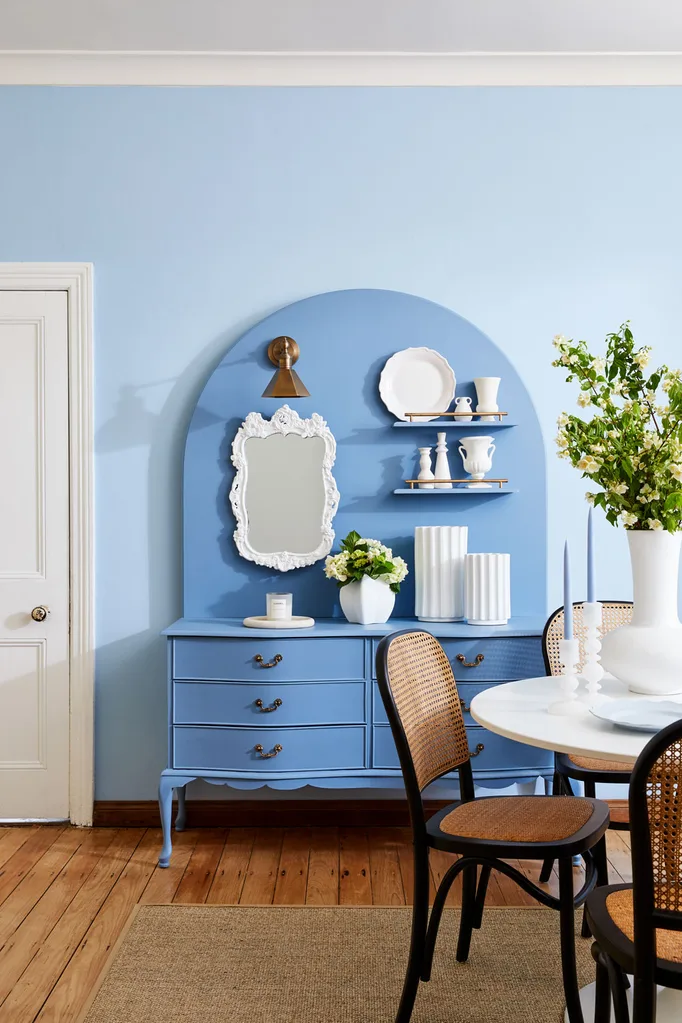 upcycled chest of drawers with blue wall and cut flowers that last longer in a vase to the right