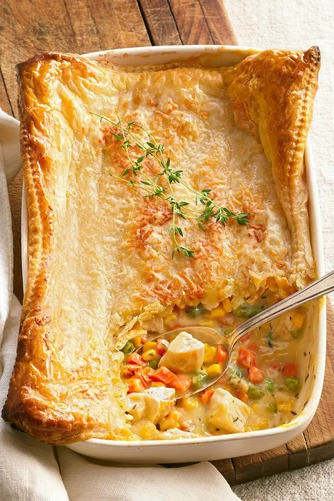 chicken and vegetable pie close up with spoon in the middle