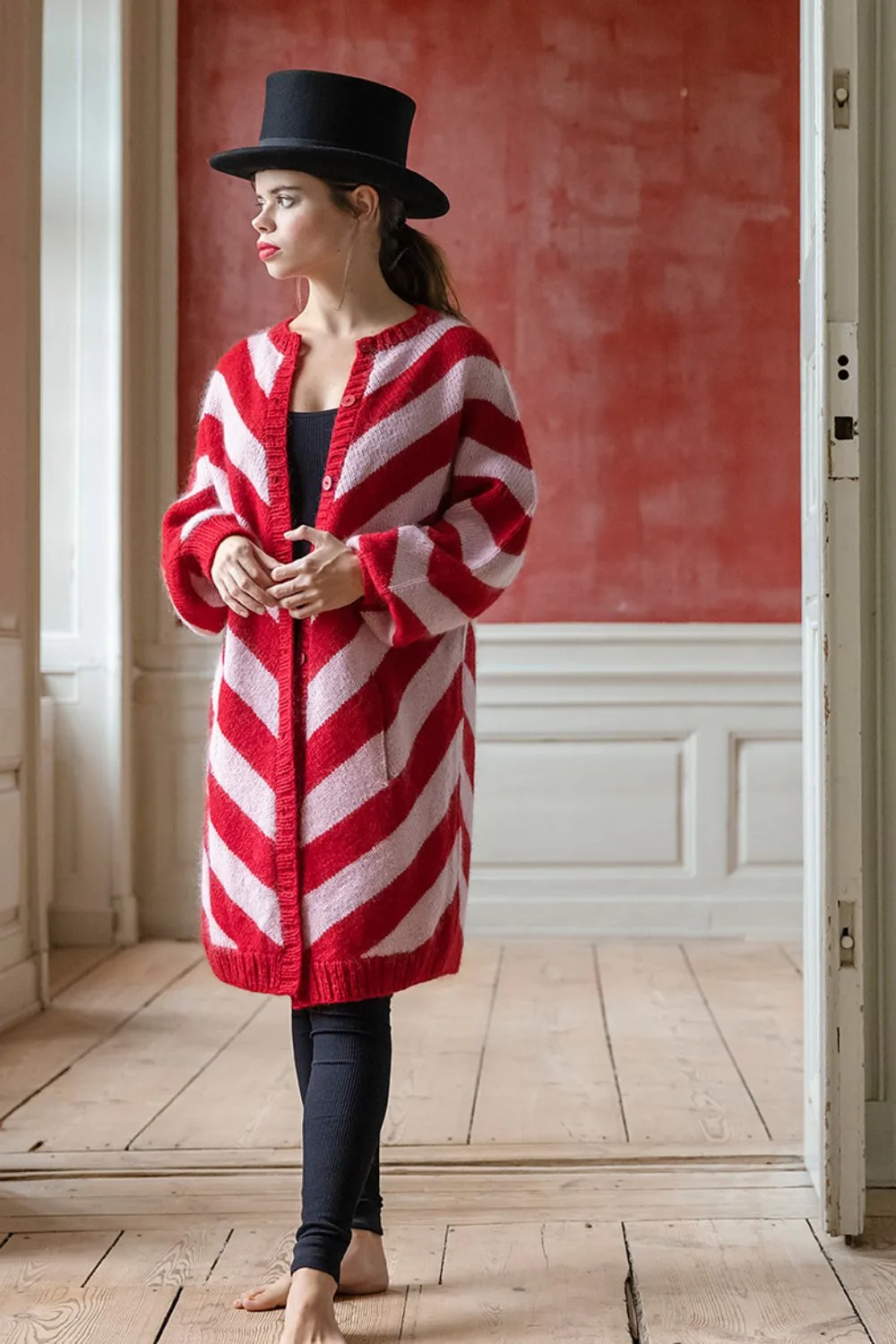 An easy pink and red striped knitted cardigan pattern free to download from Ravelry.