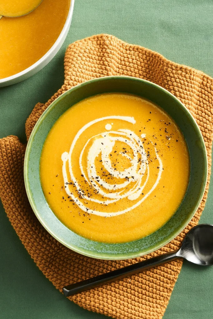 pumpkin soup with swirl of cream and pepper on top