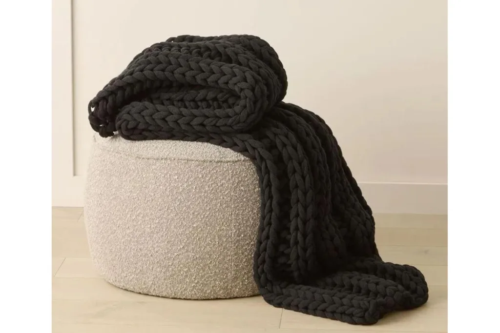 adairs newport chunky knit throw on pouf chair