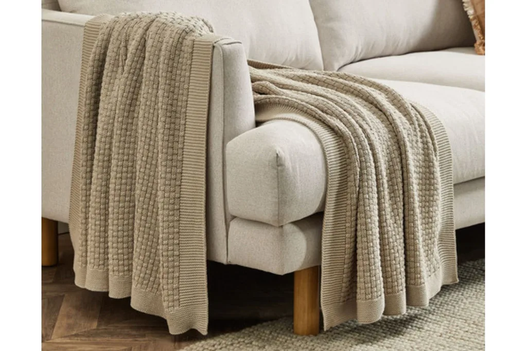 temple & webster hand knitted cotton throw over couch