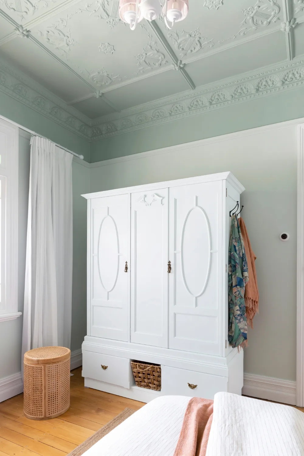 after of wardrobe makeover painted white and raised off the ground