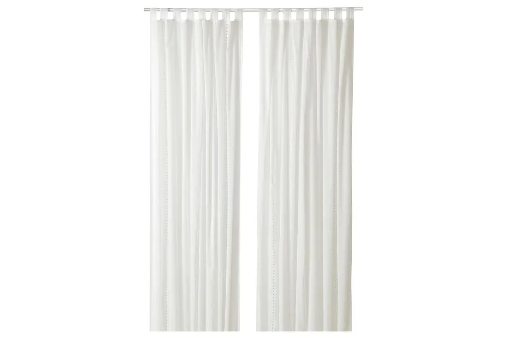 white sheer curtains with embossed holes to let the sunlight in