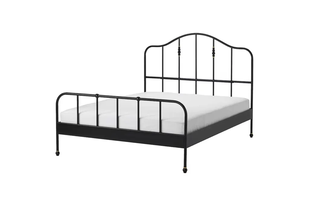 black brass bed frame with a curved headboard