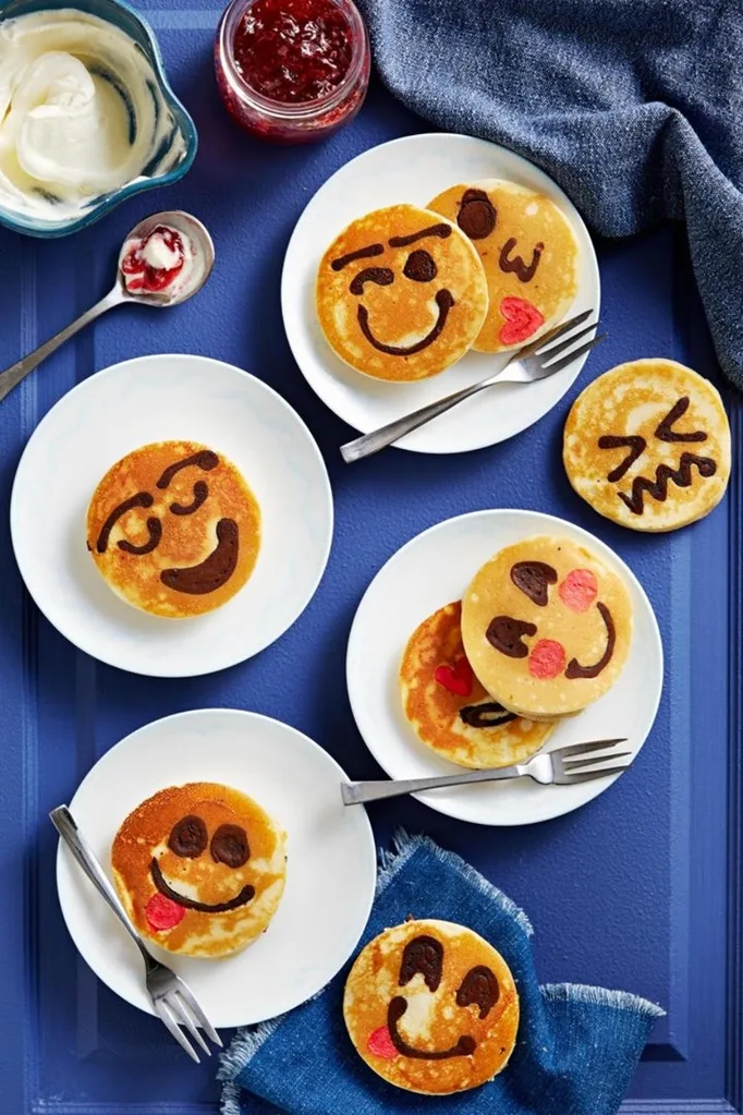 emoji pancakes recipe on plates with forks scattered