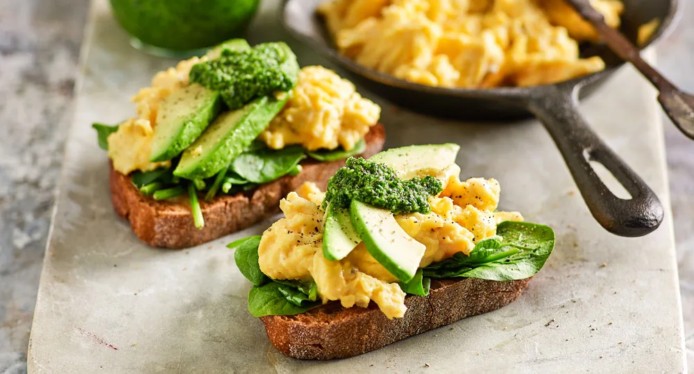 Scrambled eggs with avocado, spinach and basil pesto - Better Homes & Gardens Australia
