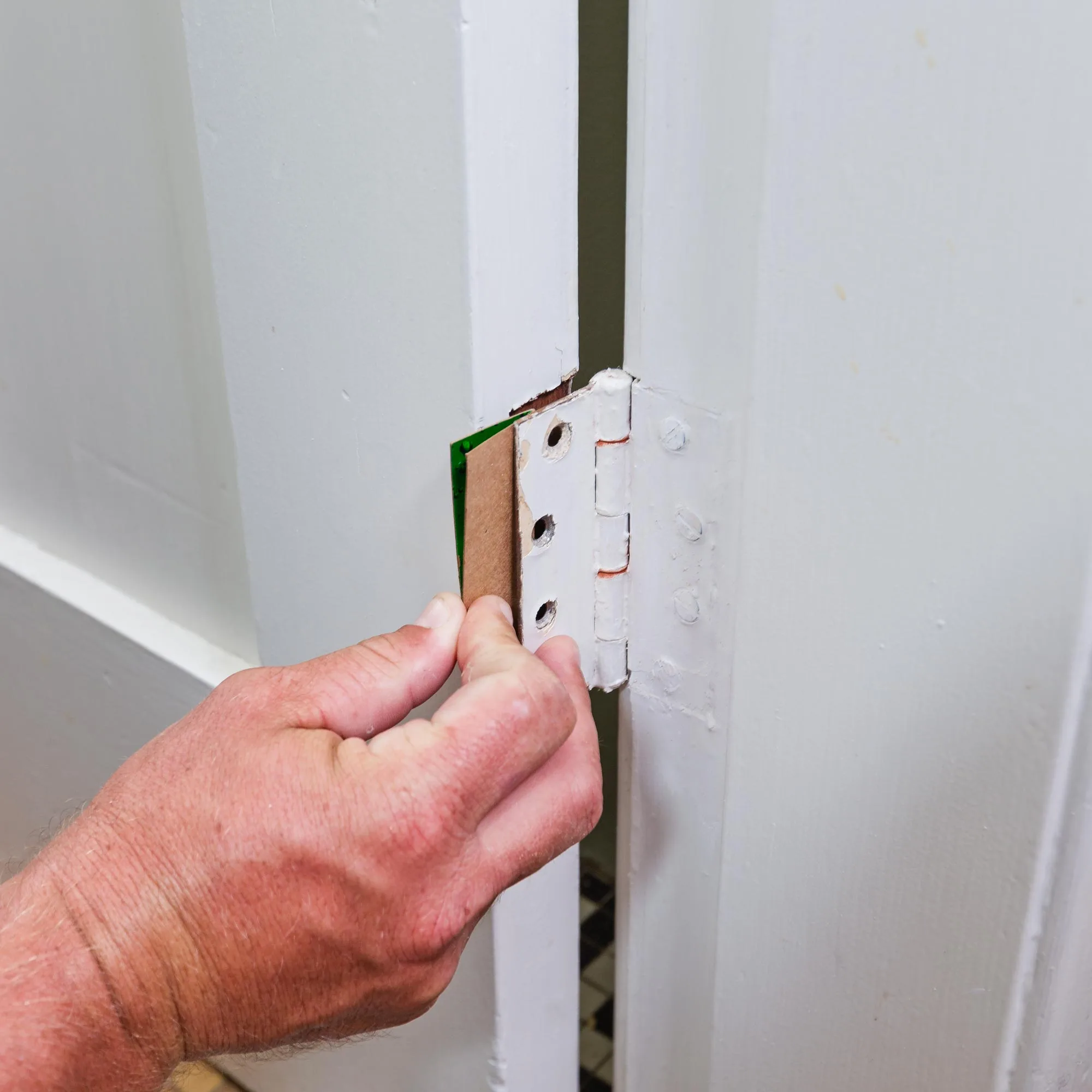 A 1mm shim can slightly lift a door to fix it scraping the floor.
