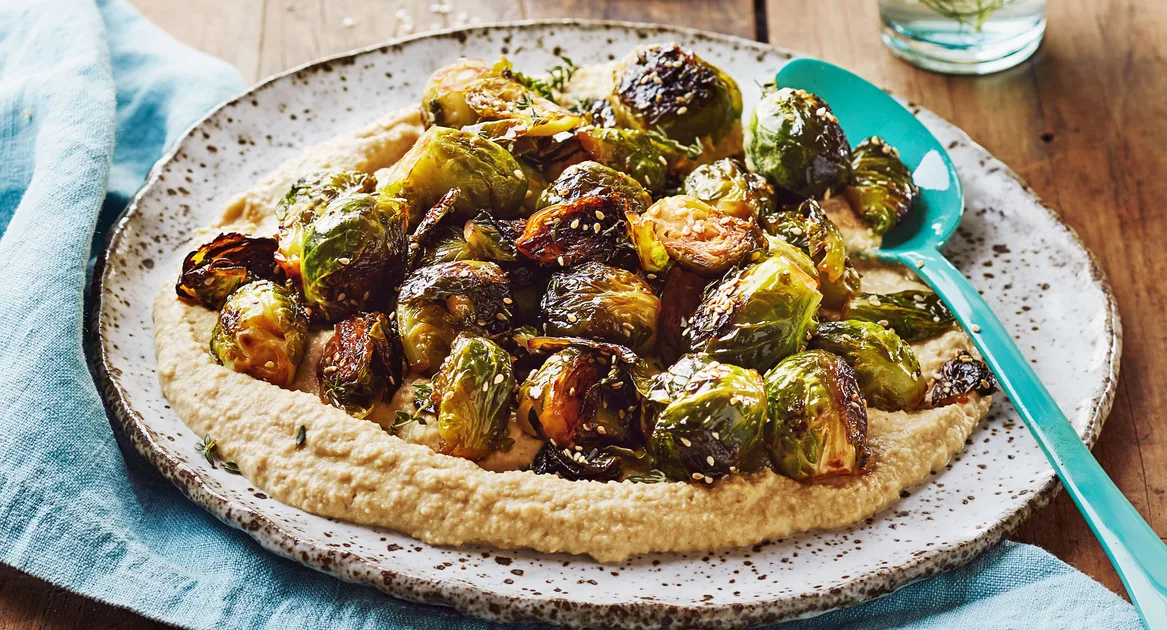 Honey-glazed brussels sprouts with sesame and hummus - Better Homes & Gardens Australia