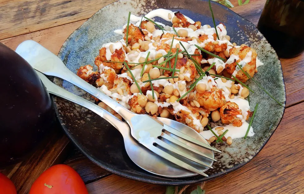 Roasted cauliflower bites with chickpeas, pine nuts and sour cream dressing - Better Homes & Gardens