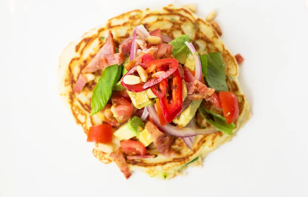 Savoury zucchini pancakes topped with bacon, basil and balsamic vinegar - Better Homes & Gardens Aus