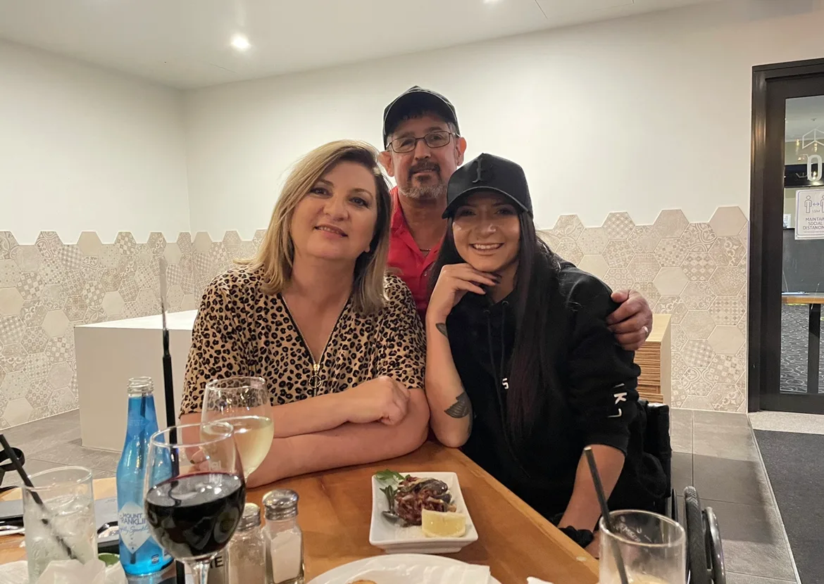 Mum, stepdad and daughter posing for family photo