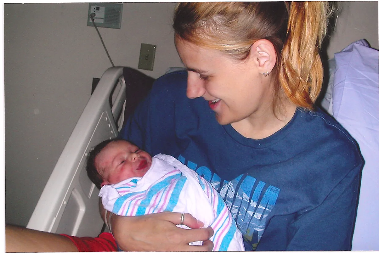 Woman holding her newborn daughter for the first time in hospital