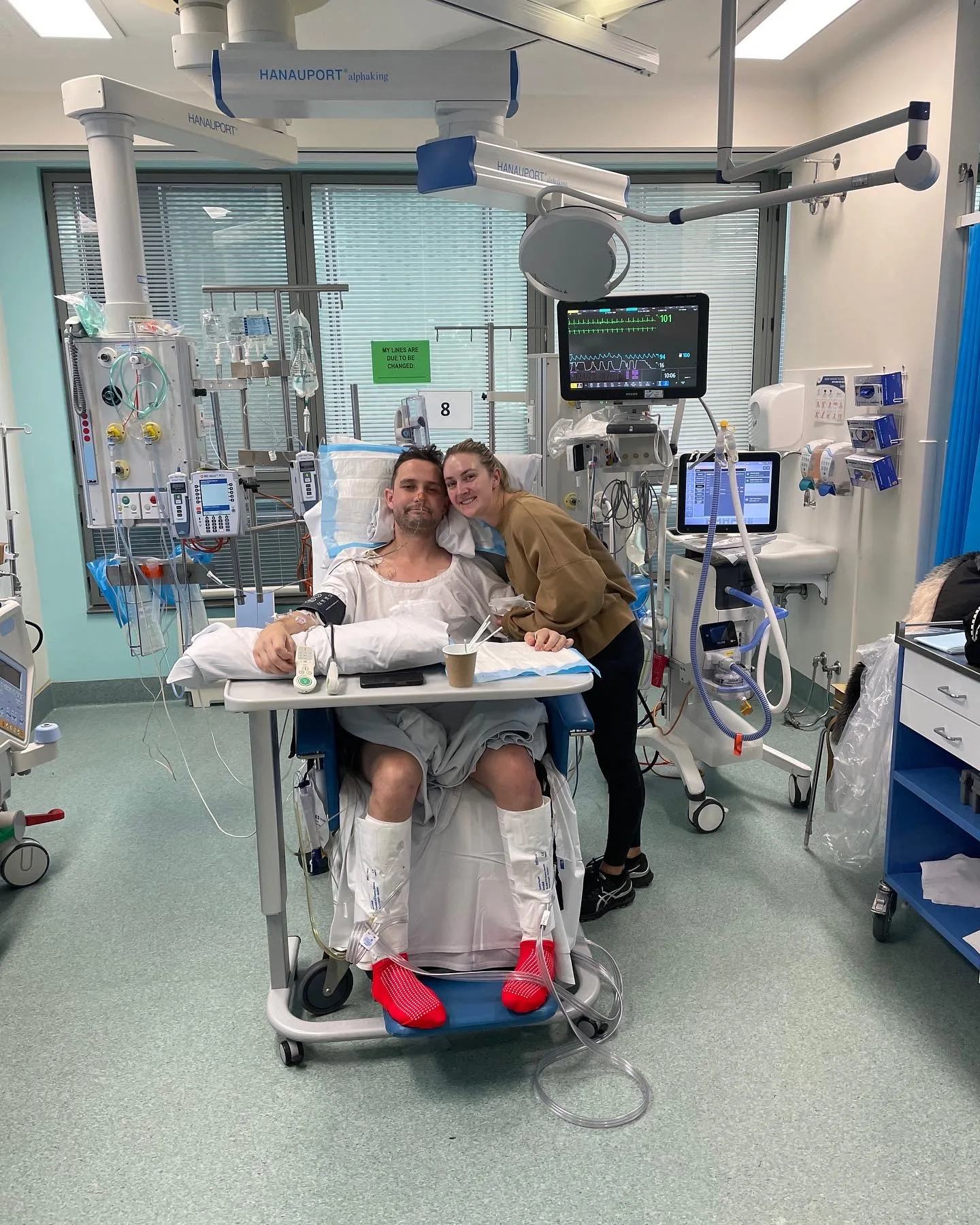 Picture of man recovering in the ICU with his partner