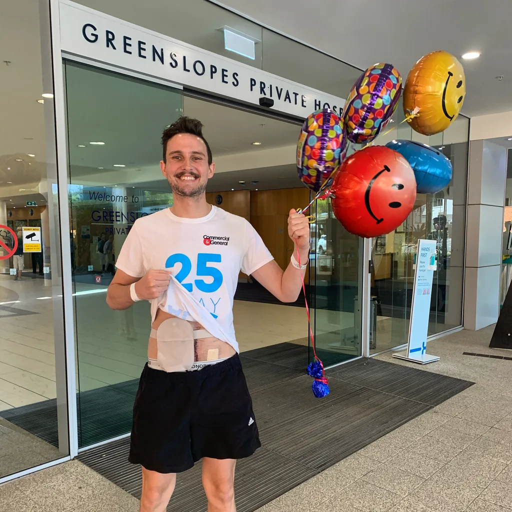 Picture of man being discharged from hospital holding balloons