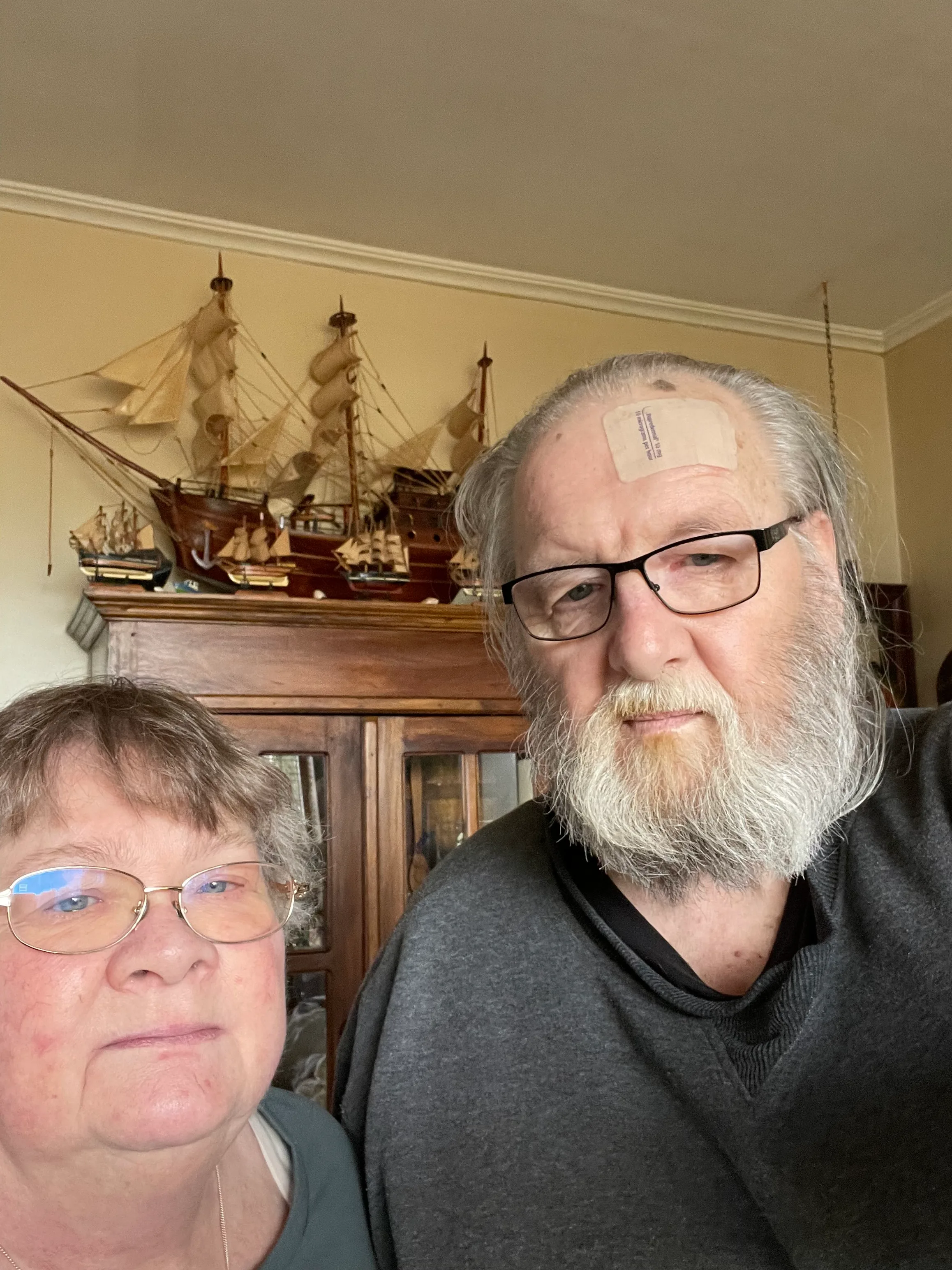 Photo of man and woman/carer in their living room