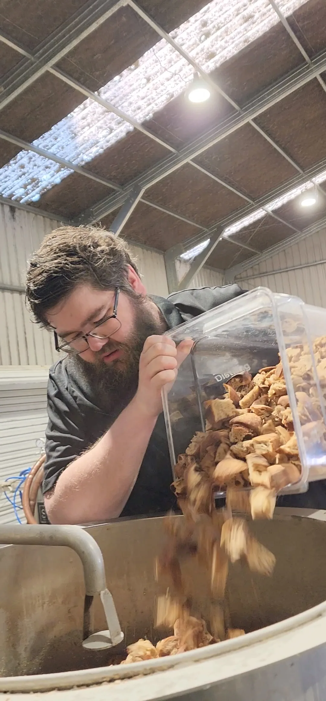 Man pouring food from a bucket