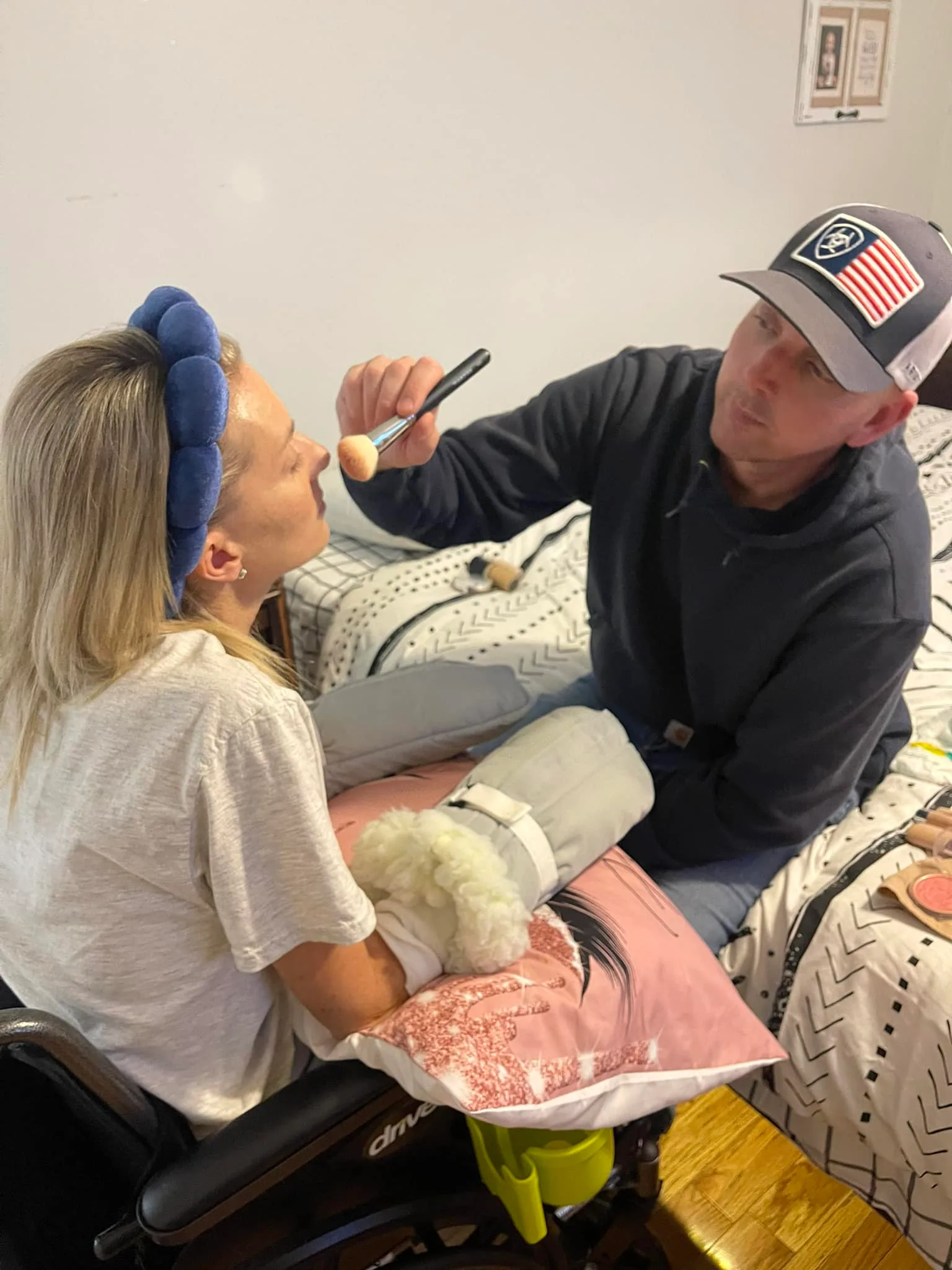 Image of husband doing wife's make-up after amputations