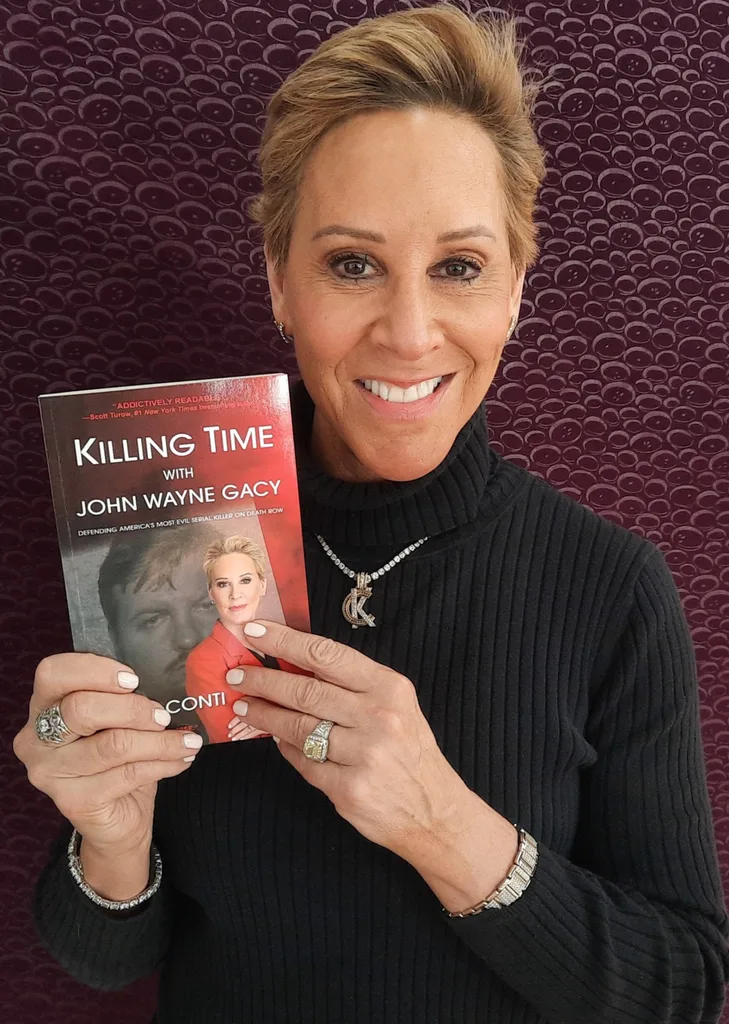 Karen Conti holding her book and smiling