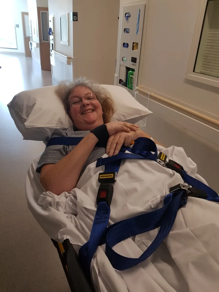 Image of woman being transported by ambulance to hospital