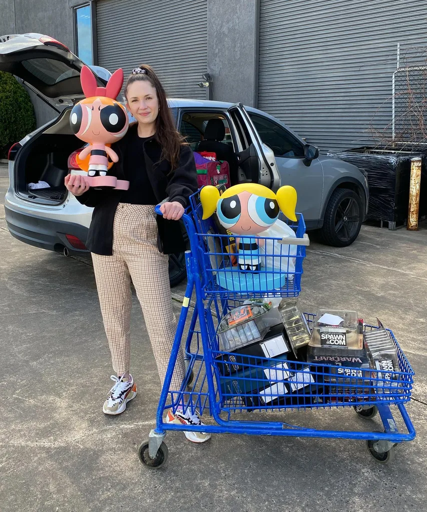 Image of woman holding stuff toys from the thrift store