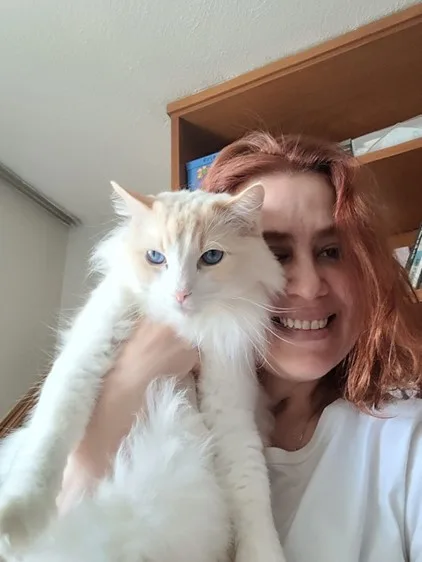 Image of woman with her white cat before being paralysed