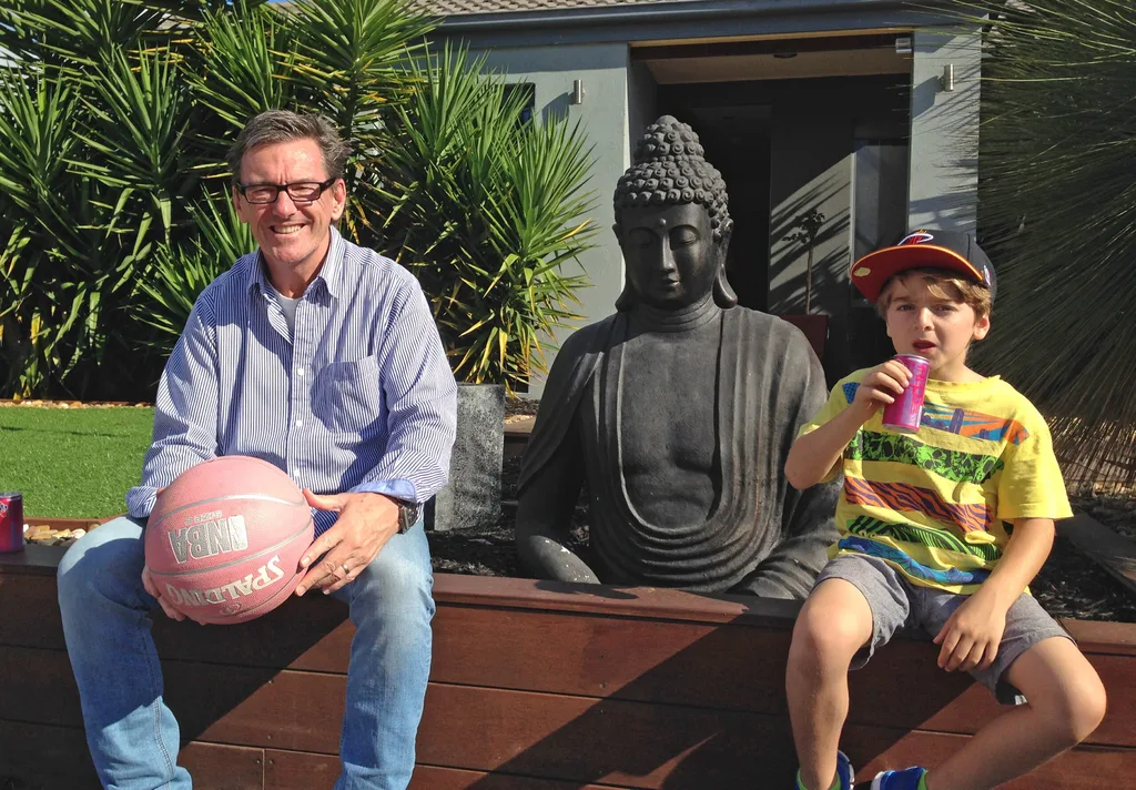 Wayne Holdsworth and his son Mac as a little boy sat on a bench