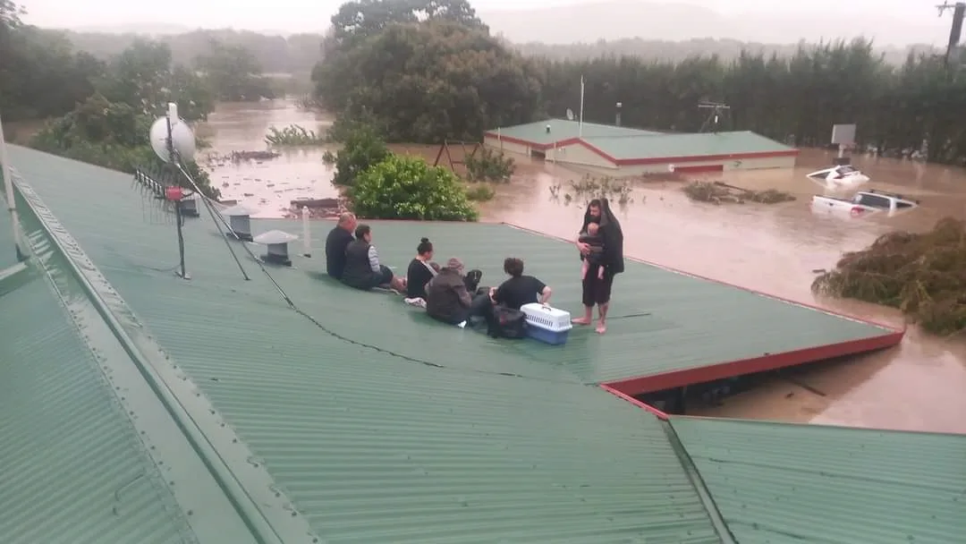 Image of family stranded on a roof during cyclone