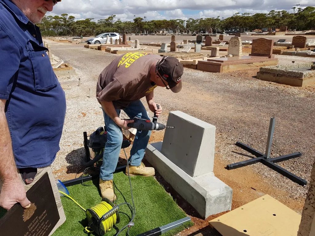 John Brownlie installing a headstone at Kimba