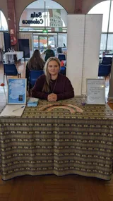 woman sitting at a table with tarot cards