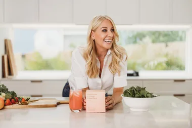 Jules owner of Pure Goddess at a kitchen counter with her products