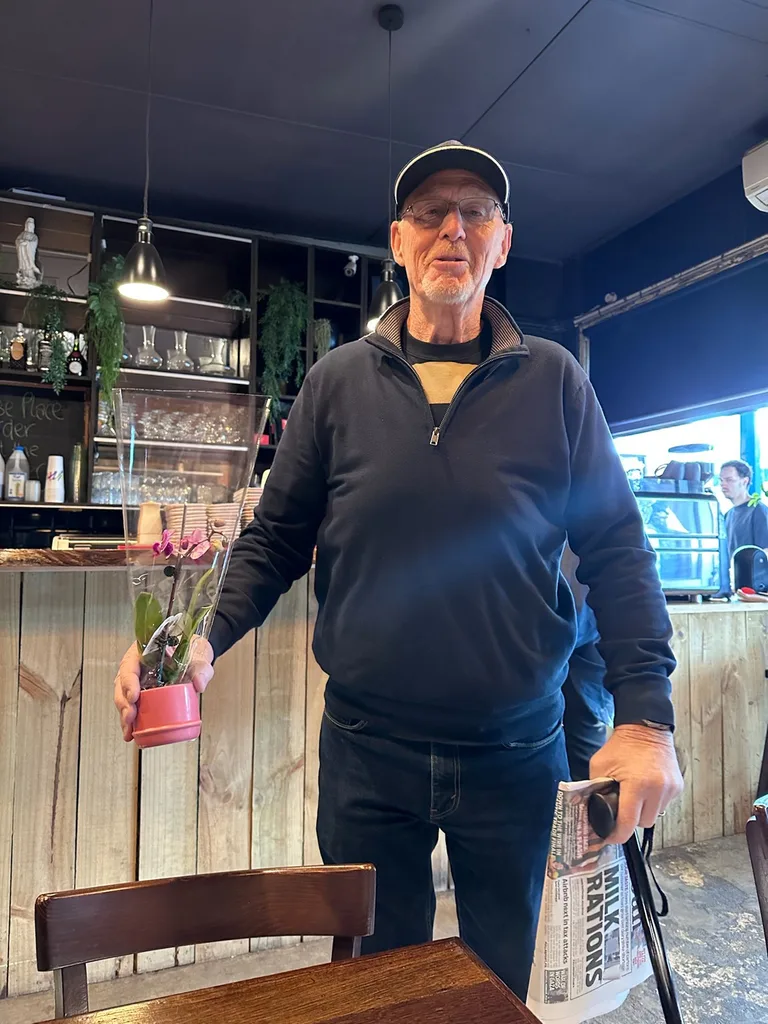 Image of man holding a flower