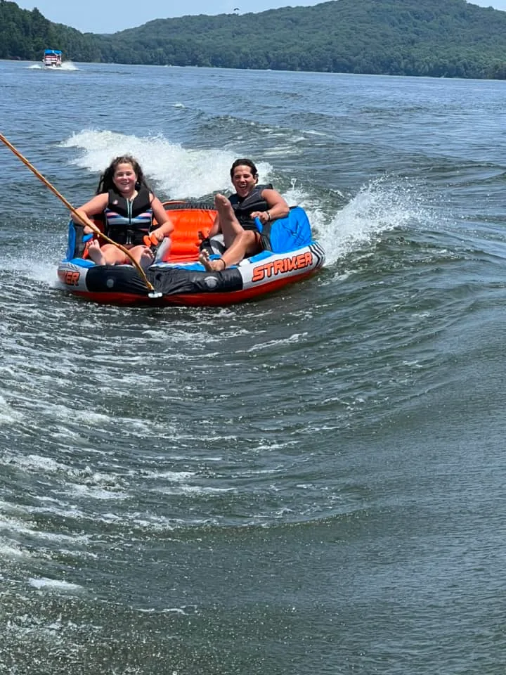 Image of two people on an inner tube
