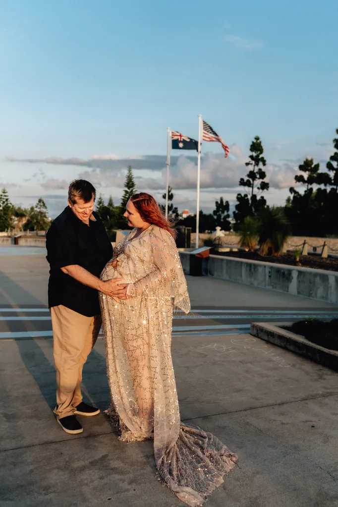 Image of husband and wife doing maternity shoot for twins