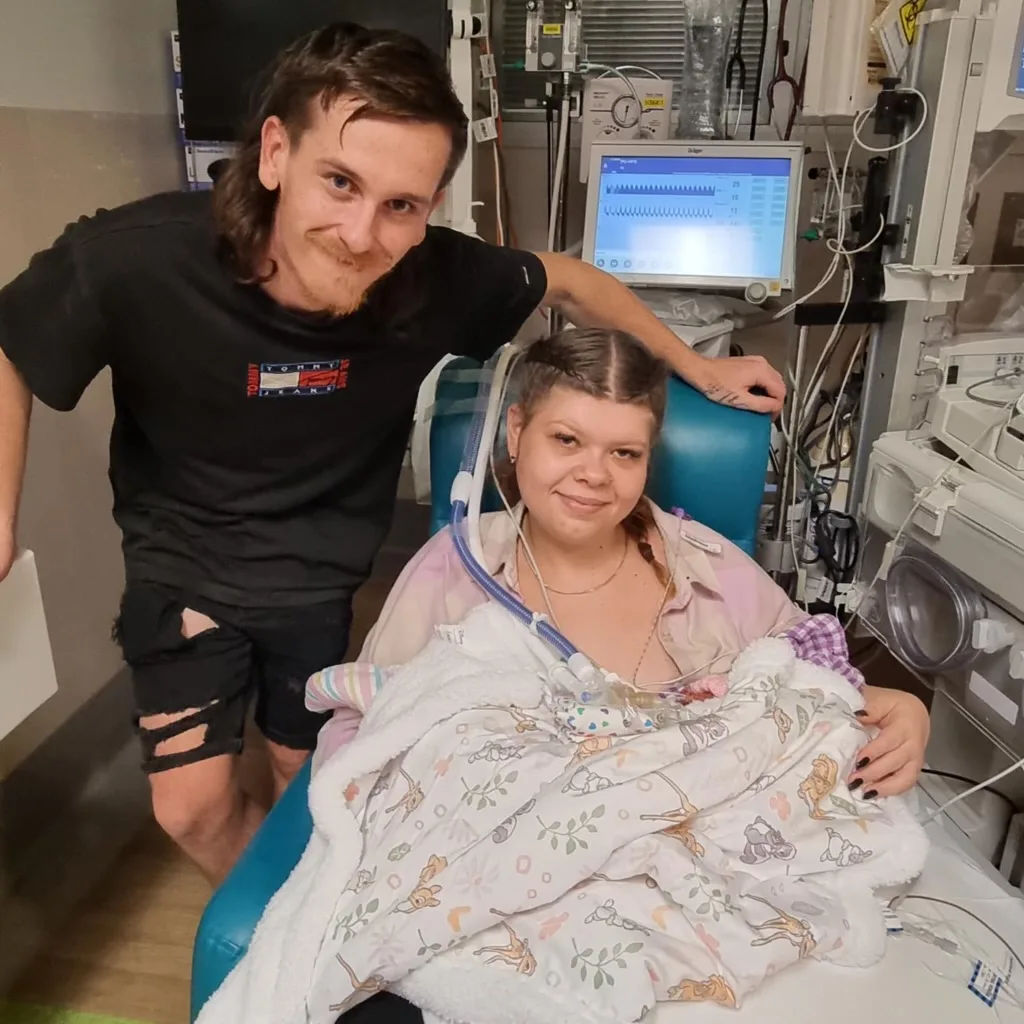 Image of mum, dad and newborn baby in hospital