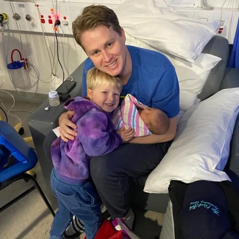 Image of father and two children in hospital
