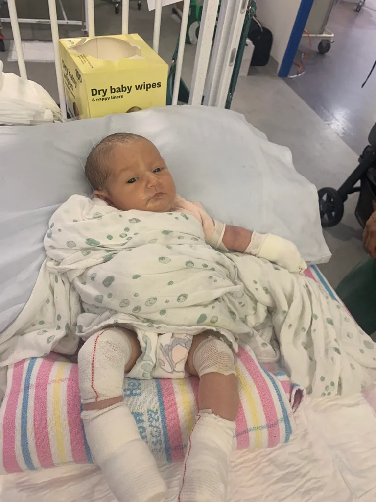 Image of newborn girl wrapped in bandages