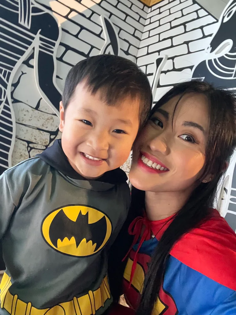 Hollie wearing a superwoman costume and Noah wearing a batman costume