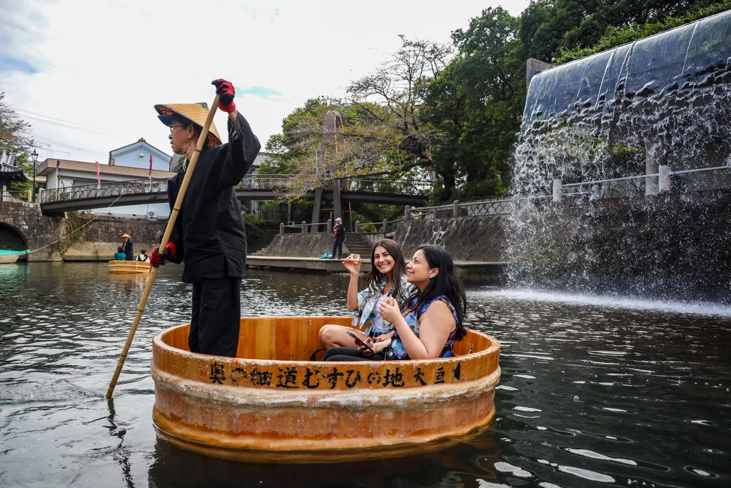 Image of woman riding in a traditional japanese wash tub
